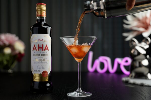 AHA POLITAN is poured from the shaker into the glass.
